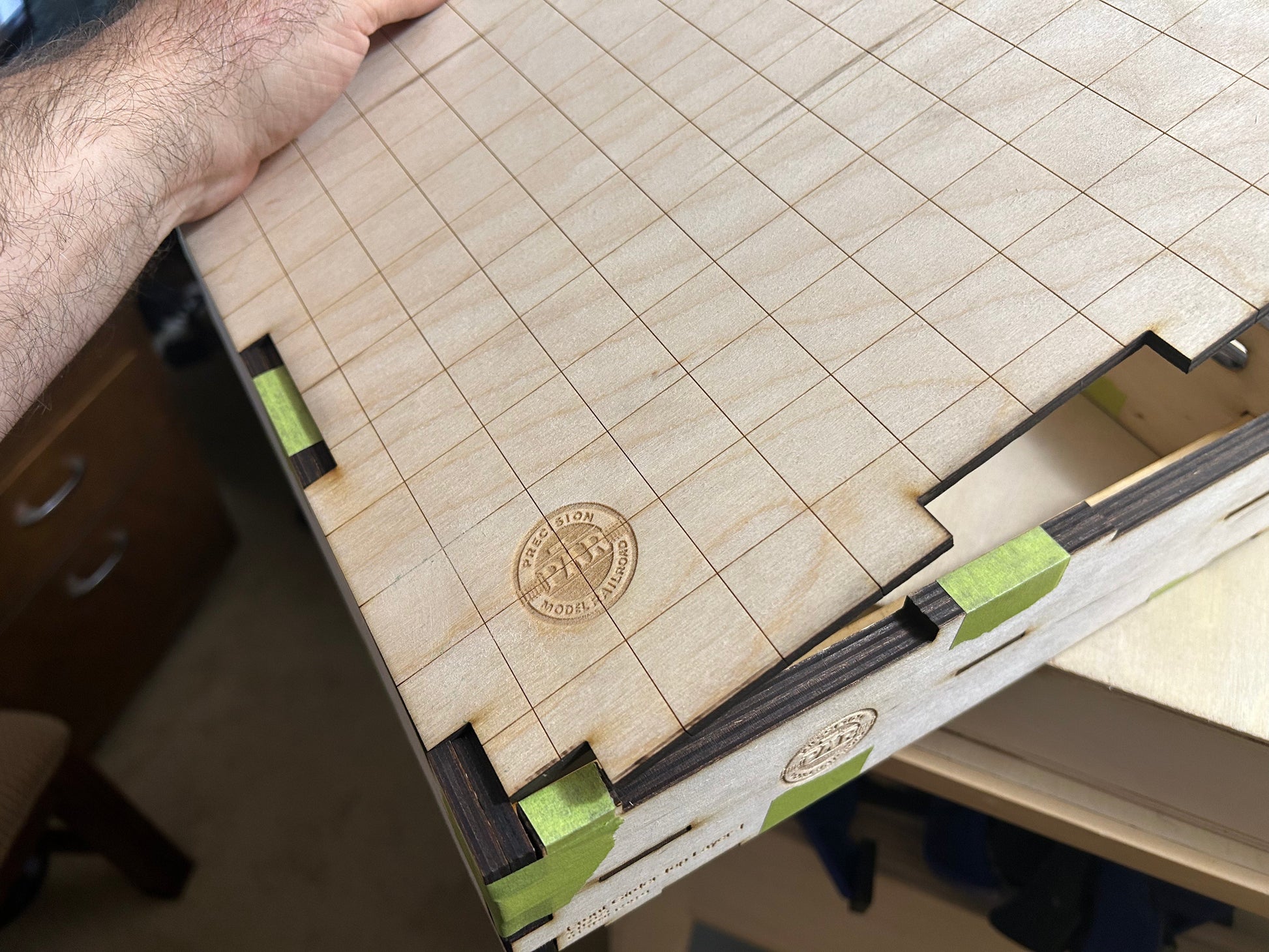The engraved grid ply top fits into the frame and is secured with glue.