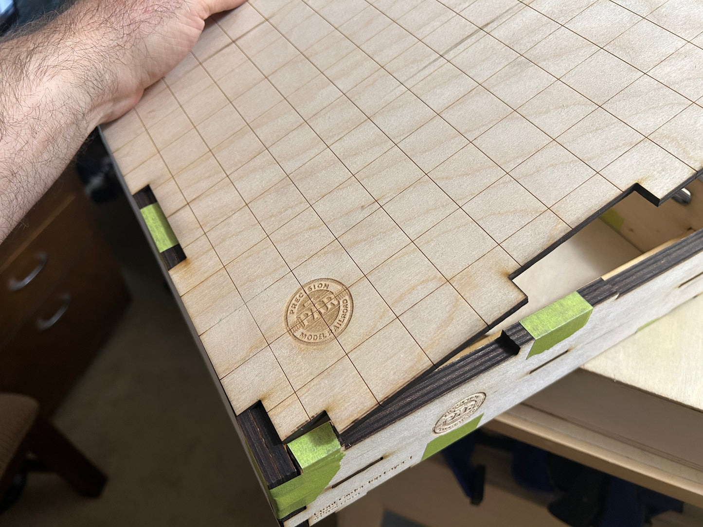 The engraved grid ply top fits into the frame and is secured with glue.
